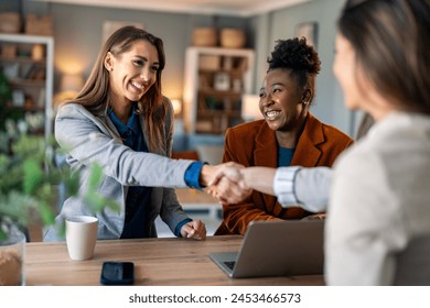 Business women shaking hands. Recruitment concept to hiring of a new talented specialists for an international company. - Powered by Shutterstock