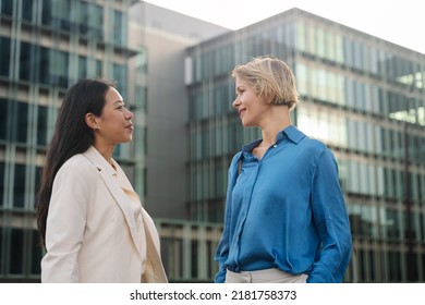 Business Women Talking Outdoors The Workplace, Caucasian And Asian Female Coworkers In The City