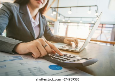 Business Women Using Calculator.