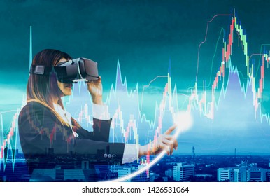 Business women wearing VR headsets using finger touch to check stock charts,holographic screen interface,concept of  speculation from currency exchange rates and volatility stock trading stock market