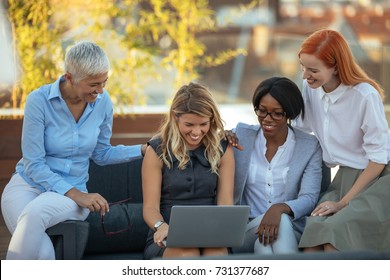 Business Women Working Together On A Laptop Outdoors.