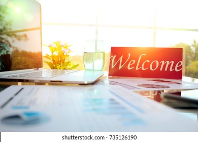  Business Work Place With Welcome Sign On The Table In The Office