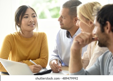 Business Workgroup Interacting In Office