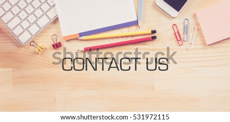 Business Workplace with  CONTACT US Concept on Wooden Background