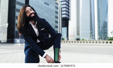 Business Young Man With Disability Adjusting His Prosthetic Leg Outside Office