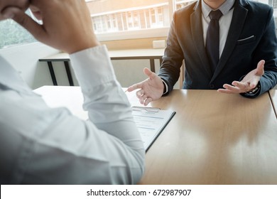 Business - young man explaining about his profile to business managers sitting in job Interview. - Shutterstock ID 672987907