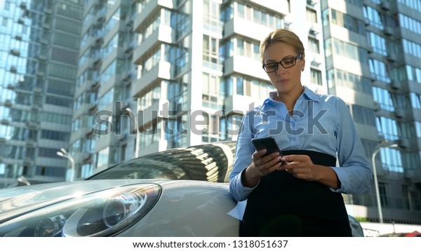Businesslady reading emails on smartphone,\
checking schedule, busy\
lifestyle