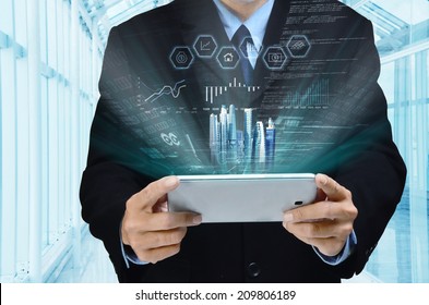 A businessman accessing internet and information technology via tablet / gadget in his hand