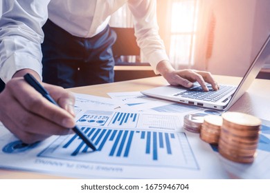 Businessman Accountant Or Financial Expert Analyze Business Report Graph And Finance Chart At Corporate Office. Concept Of Finance Economy, Banking Business And Stock Market Research.