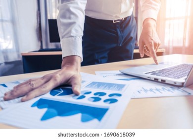 Businessman Accountant Or Financial Expert Analyze Business Report Graph And Finance Chart At Corporate Office. Concept Of Finance Economy, Banking Business And Stock Market Research.