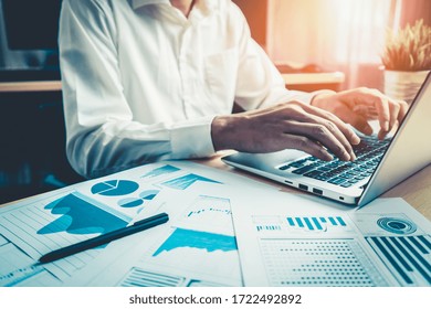 Businessman Accountant Or Financial Expert Analyze Business Report Graph And Finance Chart At Corporate Office. Concept Of Finance Economy, Banking Business And Stock Market Research.