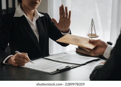 Businessman or accountant is rejecting and resisting partner bribery deals in joint financial settlement, illegal anti-bribery ideas. In work - Shutterstock ID 2289978359