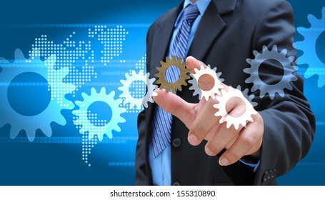 businessman adding a cog gear - Powered by Shutterstock