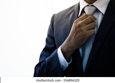 Businessman Adjust Necktie his Suit - Powered by Shutterstock