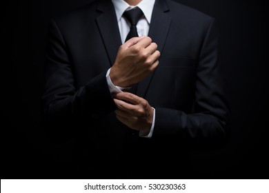 Businessman adjusting his cufflinks
