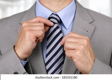 Businessman adjusting his necktie concept for anxiety, worried, meeting or ready for business