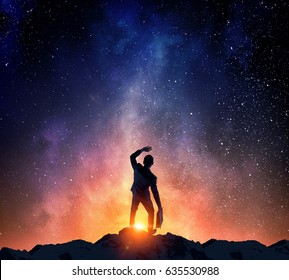 Businessman against starry sky . Mixed media - Shutterstock ID 635530988