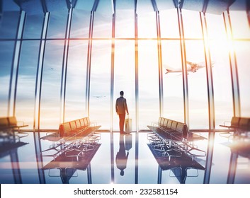 Businessman at airport with suitcase - Powered by Shutterstock