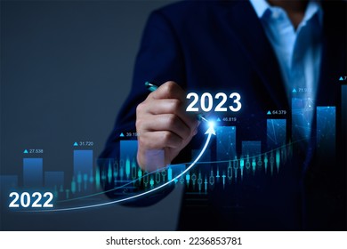 Businessman analysis profitability of working companies with digital augmented reality graphics, positive indicators in 2023, businessman calculates financial data for long term investments - Shutterstock ID 2236853781