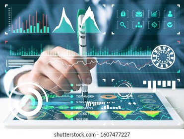 Businessman Analysis Trading Diagram At Tablet Computer. Statistical Model Prediction To Provide Insights For Financial And Marketing Strategy Decisions. Financial Infographics At Virtual Screen.