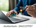 Businessman analyzes business goals and growth in 2025, planning and vision for 2025, planning business opportunities and strategies, revenue, profits, global economic trends.