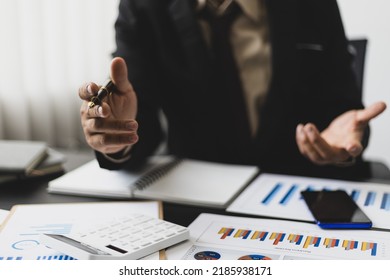Businessman analyzes market statistical research reports and makes financial planning, investment accounting. - Shutterstock ID 2185938171