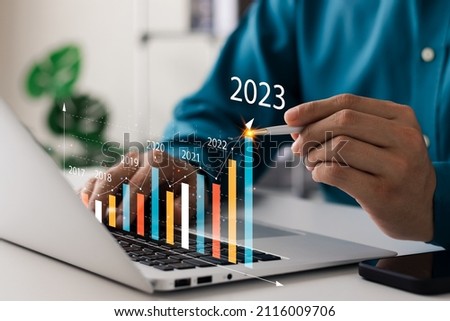 Businessman analyzes profitability of working companies with digital augmented reality graphics, positive indicators in 2023, businessman calculates financial data for long-term investments. Imagine de stoc © 