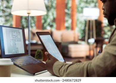 Businessman analyzing architecture blueprints for new office space layout, looking to relocate the startup. Entrepreneur conducts an office hunt, business development and strategy planning. - Powered by Shutterstock