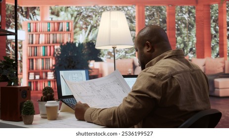 Businessman analyzing architecture blueprints for new office space layout, looking to relocate startup. Entrepreneur conducts an office hunt, business development and strategy planning. Camera B. - Powered by Shutterstock