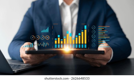 Businessman analyzing big data analytics on tablet with colorful digital graphs and charts, representing financial statistics, data visualization, and modern business intelligence tools.
