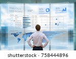 Businessman analyzing a business analytics (BA) or intelligence (BI) dashboard on virtual screen showing sales and operations data statistics charts and key performance indicators (KPI)
