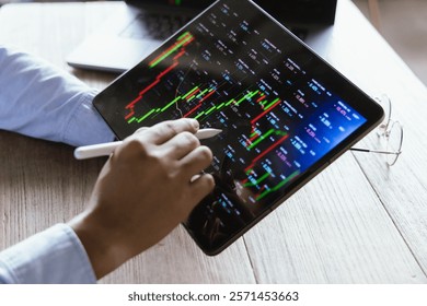 Businessman analyzing financial data by displaying charts and graphs showing global stock market and investment trends, strategies, trading and financial growth in modern office.