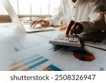 Businessman analyzing financial data with fine art fonts, reflecting investment strategies, market trends and economic growth, with an emphasis on wealth management, income and risk planning.”