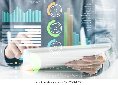 Businessman Analyzing Financial Data. Virtual 3d Interface Above Tablet Computer Screen. Interactive Financial Diagrams And Digital Data Visualization. Modern Smart Technology In Business Process