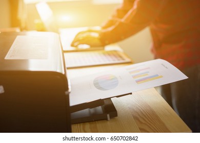 Businessman analyzing investment charts and business plan with printer. Accounting, Business People Planning Strategy Analysis Office print concept,printing documents 
 vintage color 