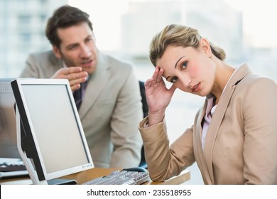 Businessman arguing with a colleague at work - Powered by Shutterstock