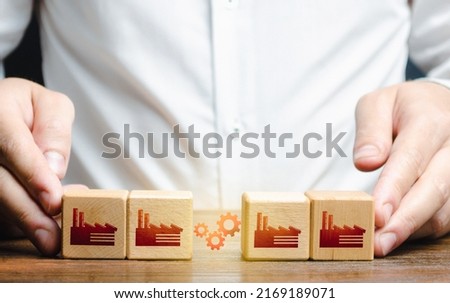 Businessman arranges work between factory productions. Industrial conglomerates and economic clusters. Collaboration and communication when working on large projects. Business globalization