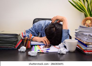 Businessman asleep at office desk with finance sheet calculator and coffee.(concept for overworked)