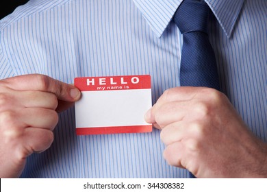 Businessman Attaching Name Tag At Conference