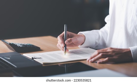 Businessman Audit documents, quality assessment management With a checklist, business document evaluation process, market data report analysis and consulting, plan review process.