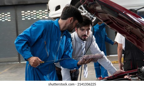 Businessman And Auto Service Mechanic Are Discussing The Work . Auto Repair Service , Focus Of Businessman