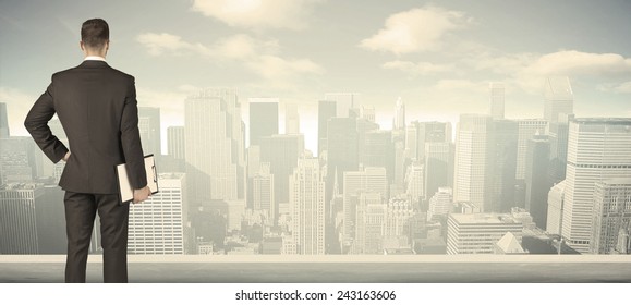 Businessman From The Back In Front Of A City View On The Window 