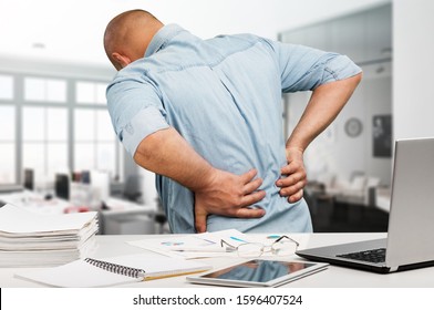 Businessman With Back Pain An Office. Pain Relief Concept