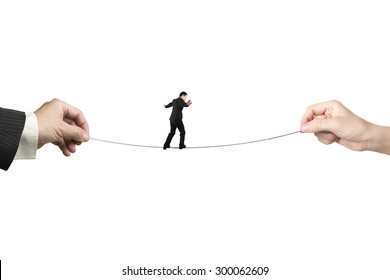 Businessman balancing on tightrope with man and woman hands holding two sides, isolated on white. - Powered by Shutterstock