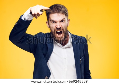 Businessman with a beard on a yellow background, emotions, portrait, boss, anger, scream, aggression.