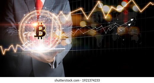 Businessman with Bitcoin currency and gold market exchange graphs. Stock market concept