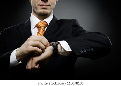 Businessman In Black Costume Wind Clock (wristwatch) On Hand