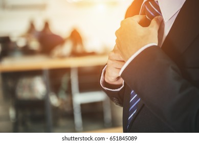 Businessman Black Suit, Straightens His Tie In An Expensive Hotel, Going To A Meeting