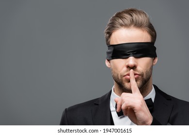 Businessman In Blindfold Showing Hush Sign Isolated On Grey