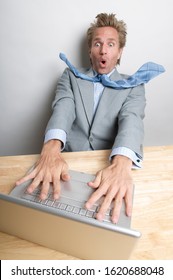 Businessman Blown Away At His Desk By The Streaming Speed On His Laptop Computer